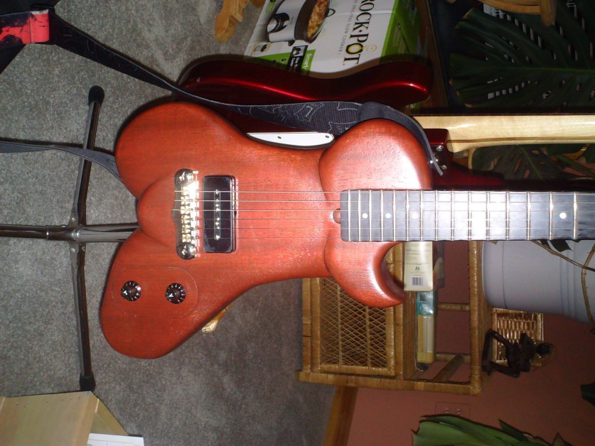 From Scott Connell: electric goddess guitar body made from mahogany reclaimed from an old piano crate. Neck is maple from a broken kids bed. I purchased the ebony for the fretboard