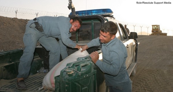 Afghan Uniformed Police unload the last bag of poppy seed from a seizure at a burn pit on Forward Operating Base Delaram 2, July 22.