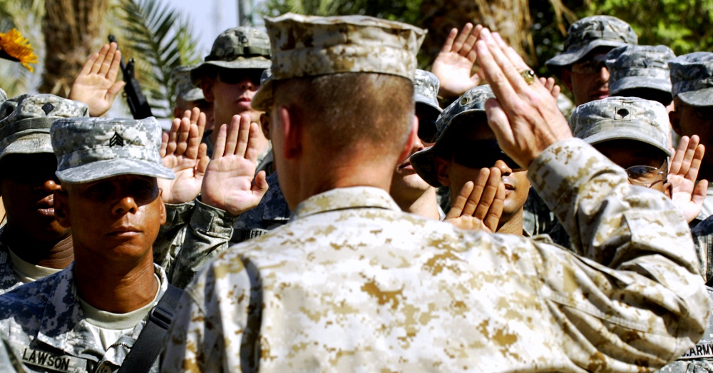 Marine Gen. Peter Pace gives the oath of enlistment to U.S. Army Soldiers during a re-enlistment ceremony at Camp Liberty, Iraq, 2007. Via The U.S. Army and Staff Sgt. D. Myles Cullen, U.S. Air Force