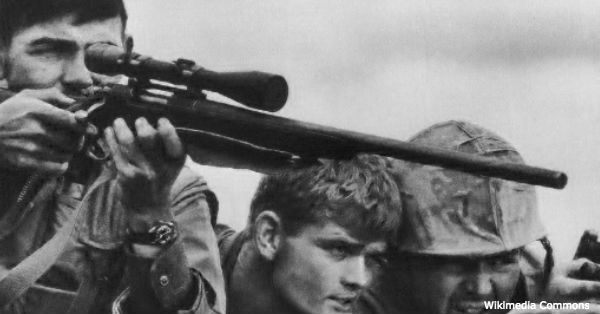 A Marine Corps sniper team searches for targets in the Khe Sanh Valley.