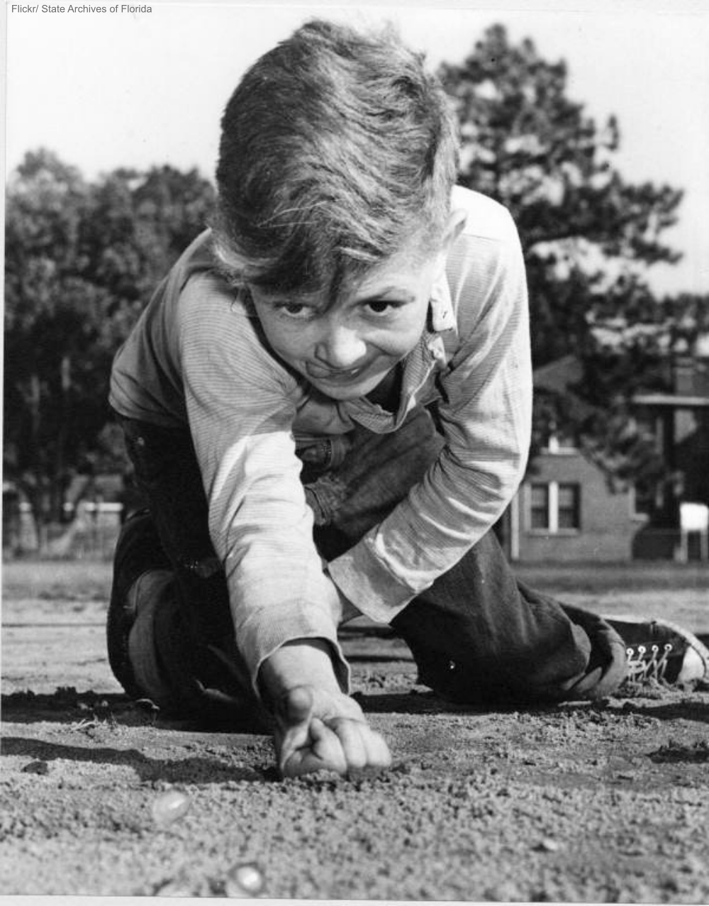 Little Boy Shooting Marbles in Ringer