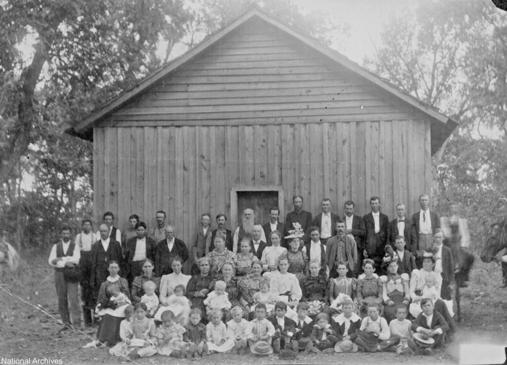 Sunday school in the old west with settlers and Indians in attendance 1900