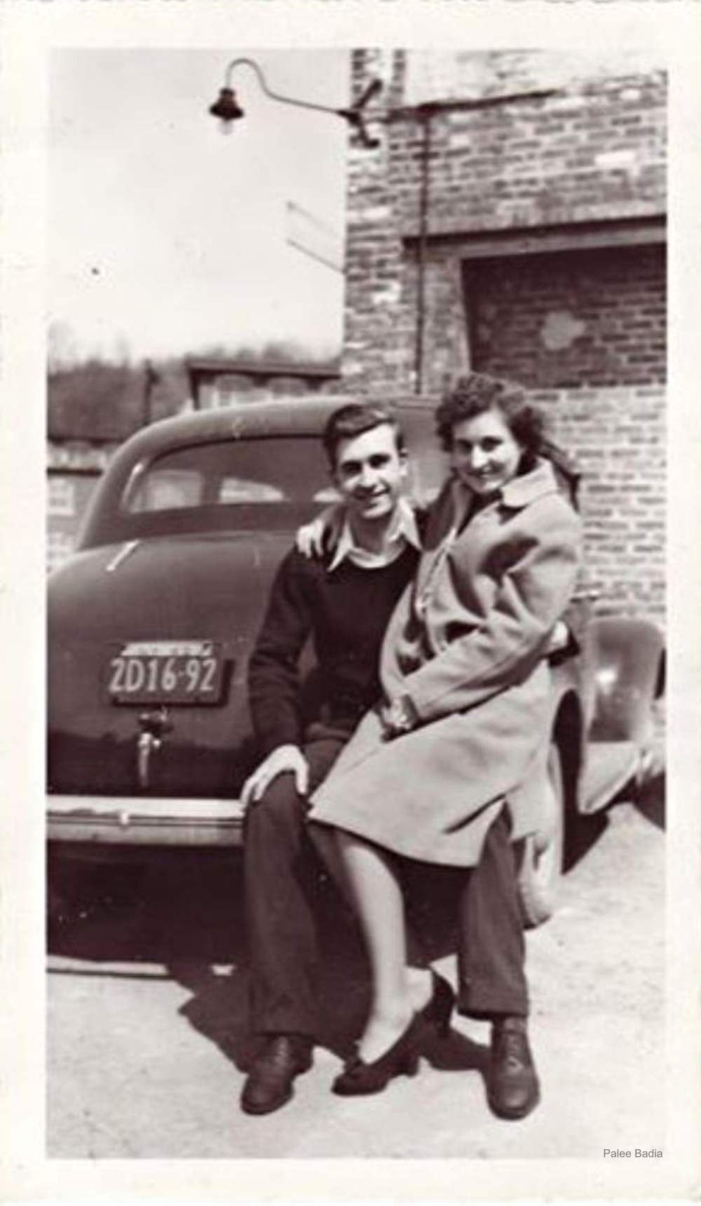 1930s couple on car bumper