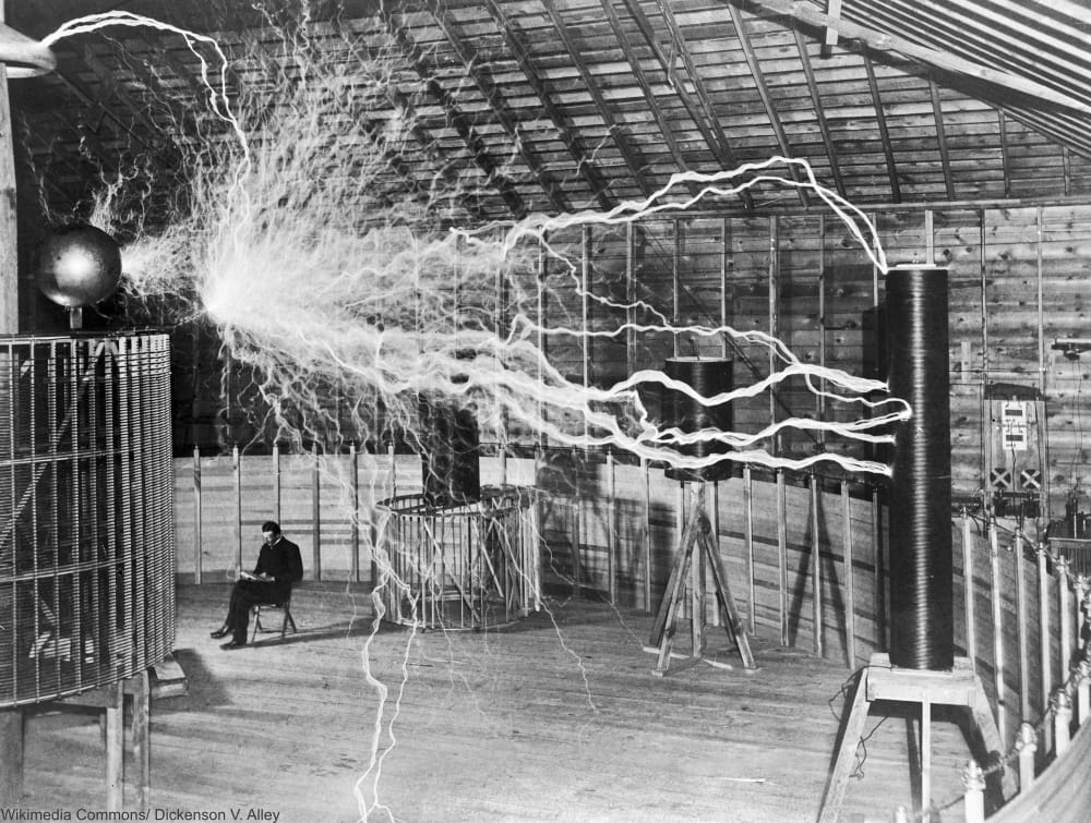 Double exposure of Nikola Tesla with his equipment