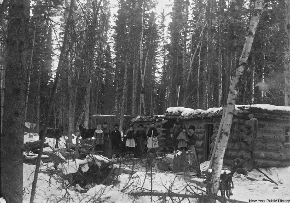 Settlers in front of their cabin in winter.