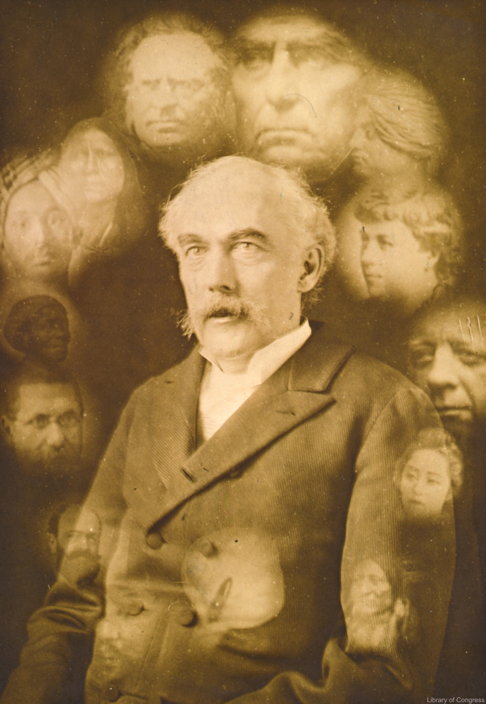 [Spirit photograph showing half-length portrait of John K. Hallowell, facing left, surrounded by super-imposed faces of fourteen deceased people