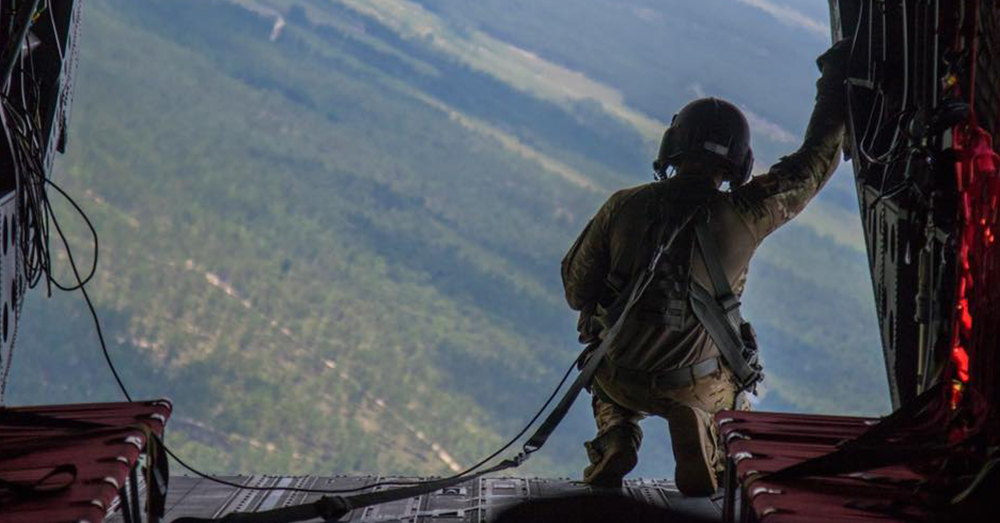 Photo: Facebook/82nd Airborne Division -- A member of the 82nd Airborne Division looks out the back hanger of an aircraft mid-flight.