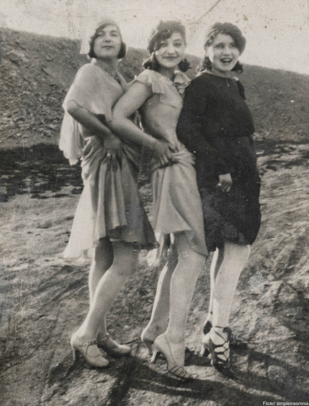 Three flappers hike their skirts