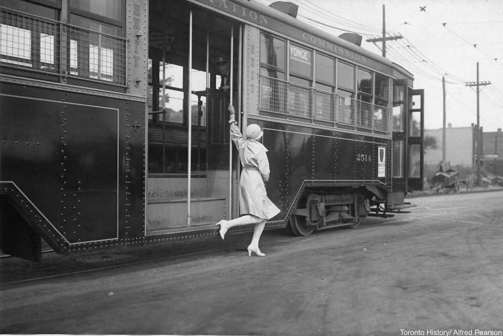 flapper trying to catch a street car