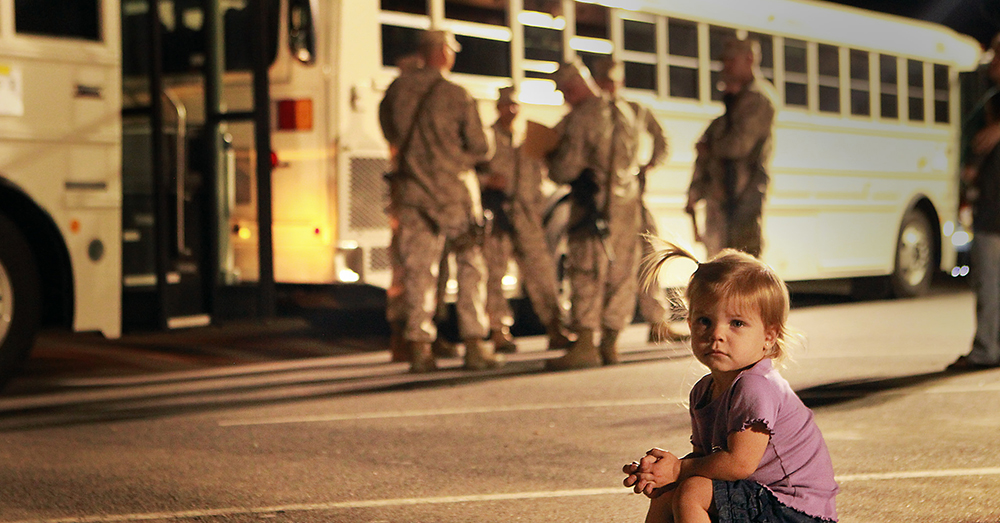 Photo: U.S. Marine Corps/Cpl. William J. Jackson -- The 22-month-old daughter of Gunnery Sgt. Jared Hoversten sits in front of buses shortly before her dad and other Marines leave for their deployment to Afghanistan.