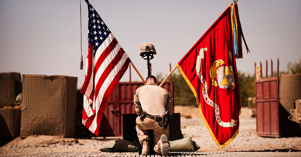 Photo: U.S. Marine Corps/Sgt. Mark Fayloga -- A Marine says goodbye to 1st Lt. Scott J. Fleming during his memorial service at Patrol Base Jaker, Afghanistan.