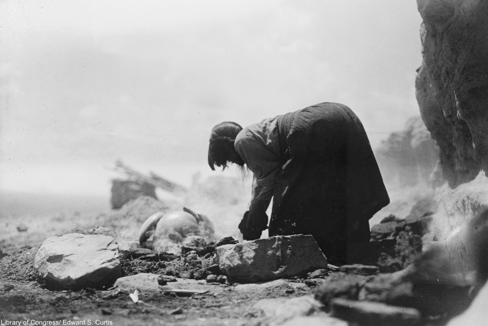 Potter building her kiln, circa 1906