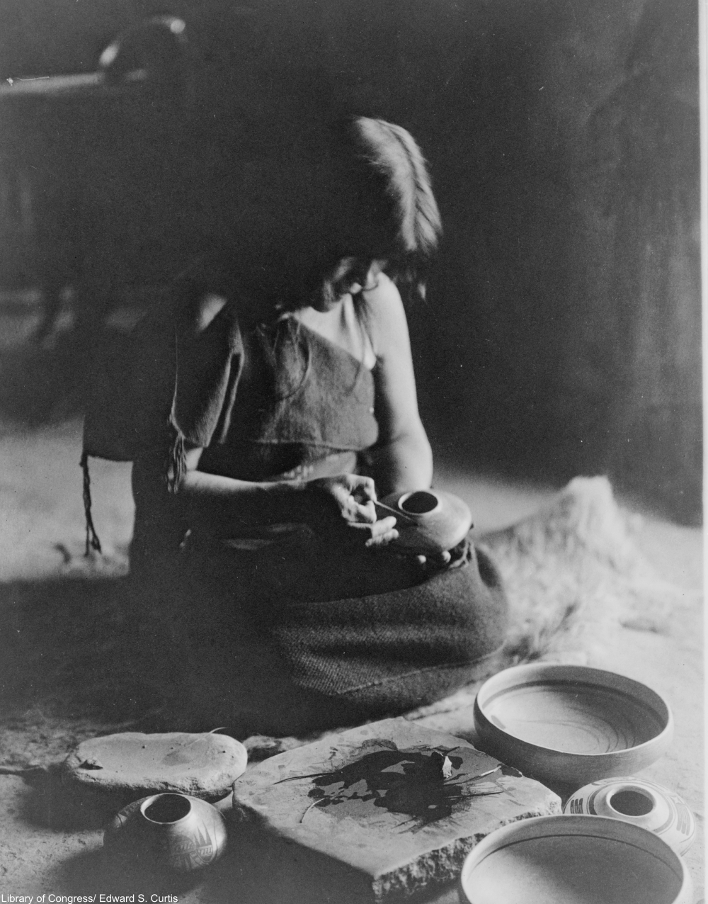 applying pigment to the pots, circa 1906