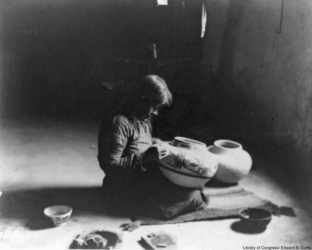 Hopi potter decorating a vessel, 1900