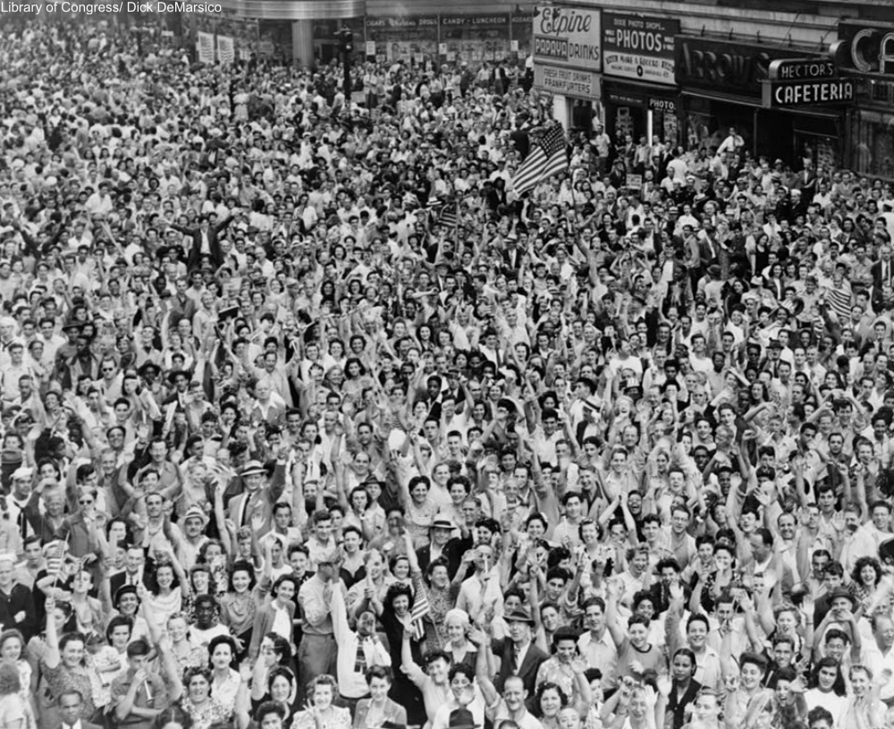 Crowd of people, many waving, in Times Square on V-J Day at time of announcement of the Japanese surrender in 1945