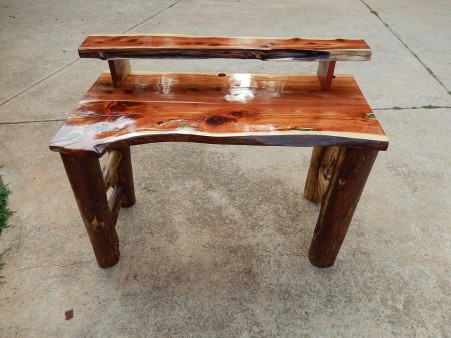 a rustic cedar computer desk I made with green resin to fill in any holes or cracks through out the desk.