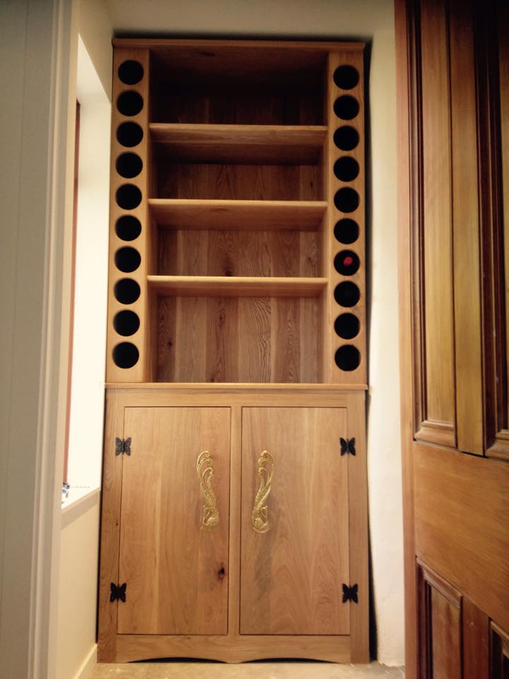 I've been working on something for a couple of months and have been waiting till its done to send a couple pics. It's a feature commissioned hallway piece made from white oak holds 20 bottles of wine and the shelving is for preserves with ample storage in underneath cupboards. This is the biggest and nicest piece I have ever made. It weighs about 140 kgs top half 80 by itself. Over 200 dowels for joints 200 biscuits for laminating all the boards together.