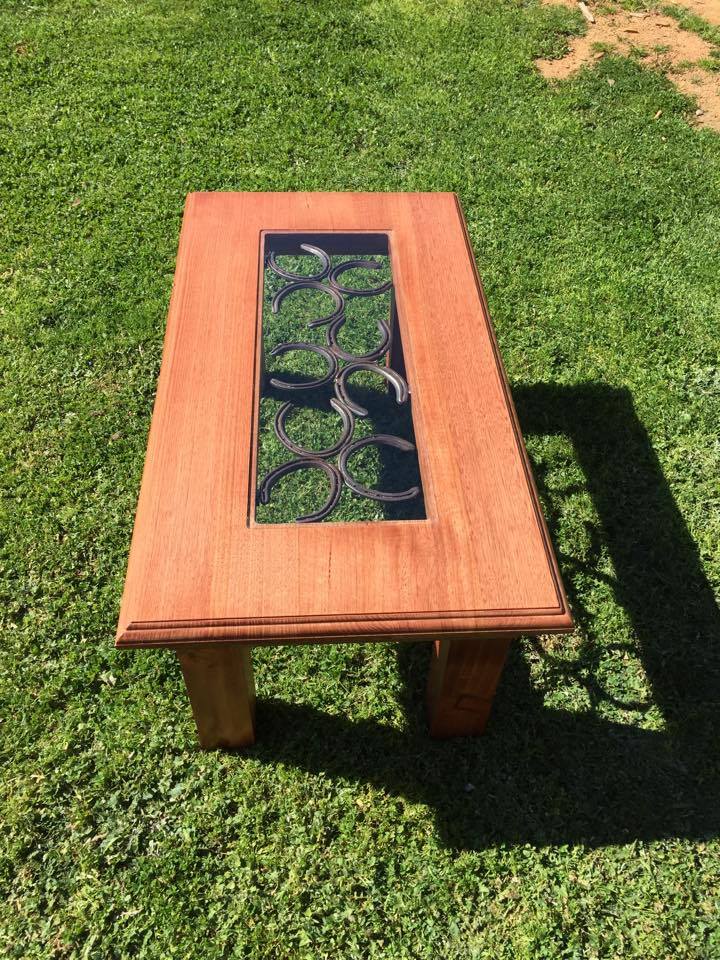 From Jemma Corbett: Coffee table I made. Top is Tasmanian oak and base is pine. Jarrah stain. 2pac lacquer. Horseshoe and glass inlay.