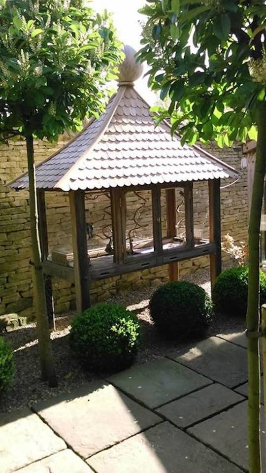 From Sandor Pacz: a parrot house I have recently made for a bird lover. I used iroko timber even for the 560 pieces of shingles. The frame is mortise and tenon jointed and a dowel goes through the joints. The ball on the top is made out of a solid block and measures 19 inches diameter.