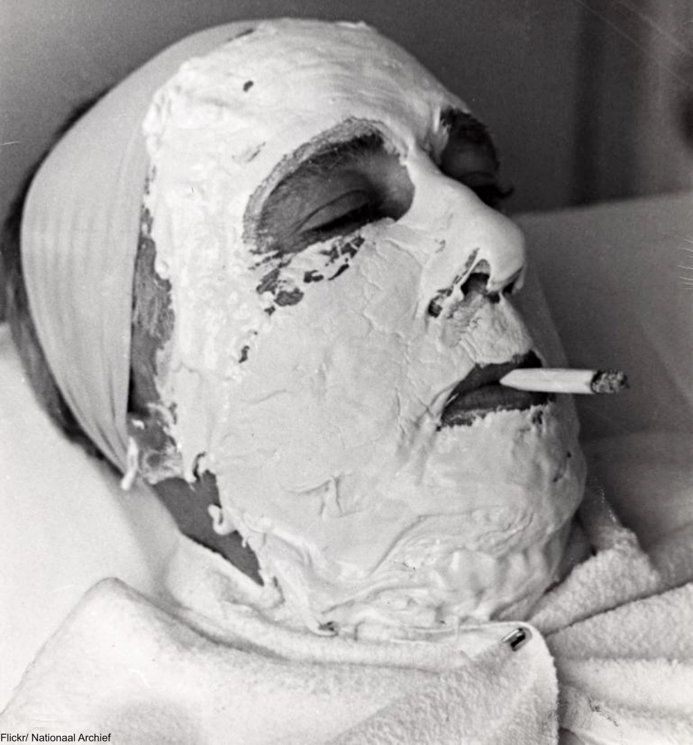 1941 Man Smoking a Cigarette While He Gets a Facial Treatment