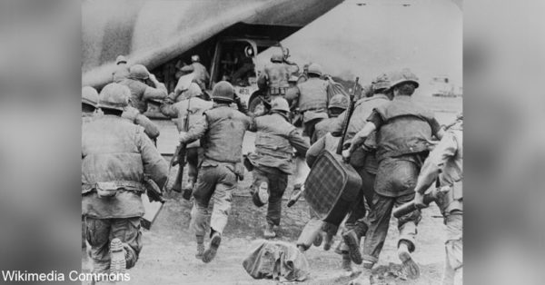 Soldiers and civilians run for the final evacuation of Khe Sanh.