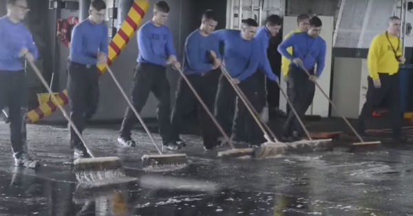 Source: YouTube/AiirSource Military A deck of the USS Harry S. Truman gets a good swabbing.