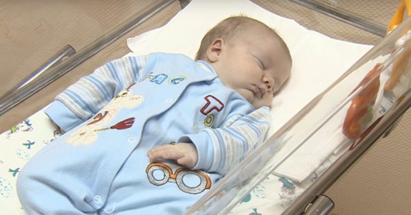 Source: YouTube/RT The baby boy Masha found in a cardboard box.