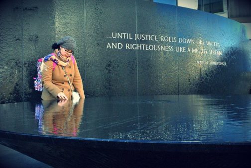 A woman pauses in reflection at the Marthin Luther King, Jr. memorial.