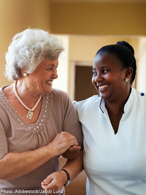 elderly woman being helped by kind nurse