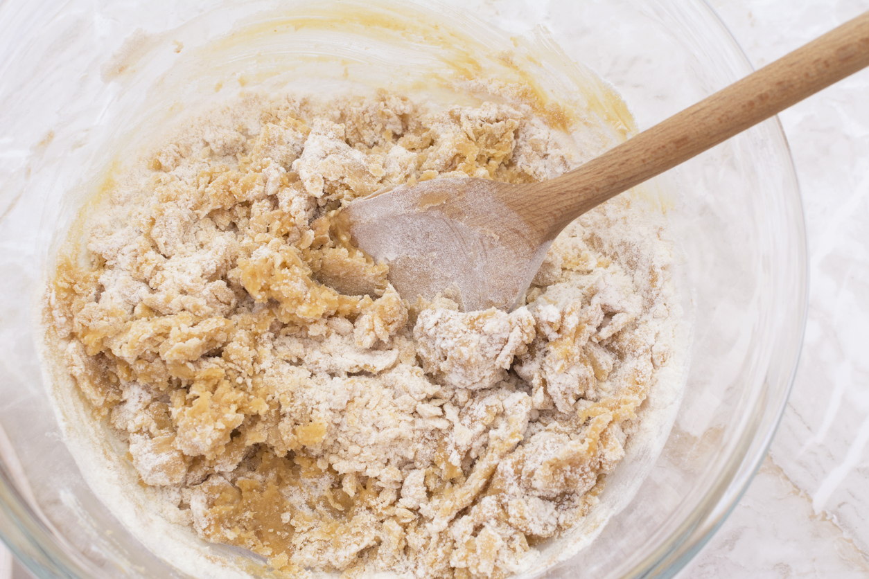 Stirring dough to make peanut butter cookies