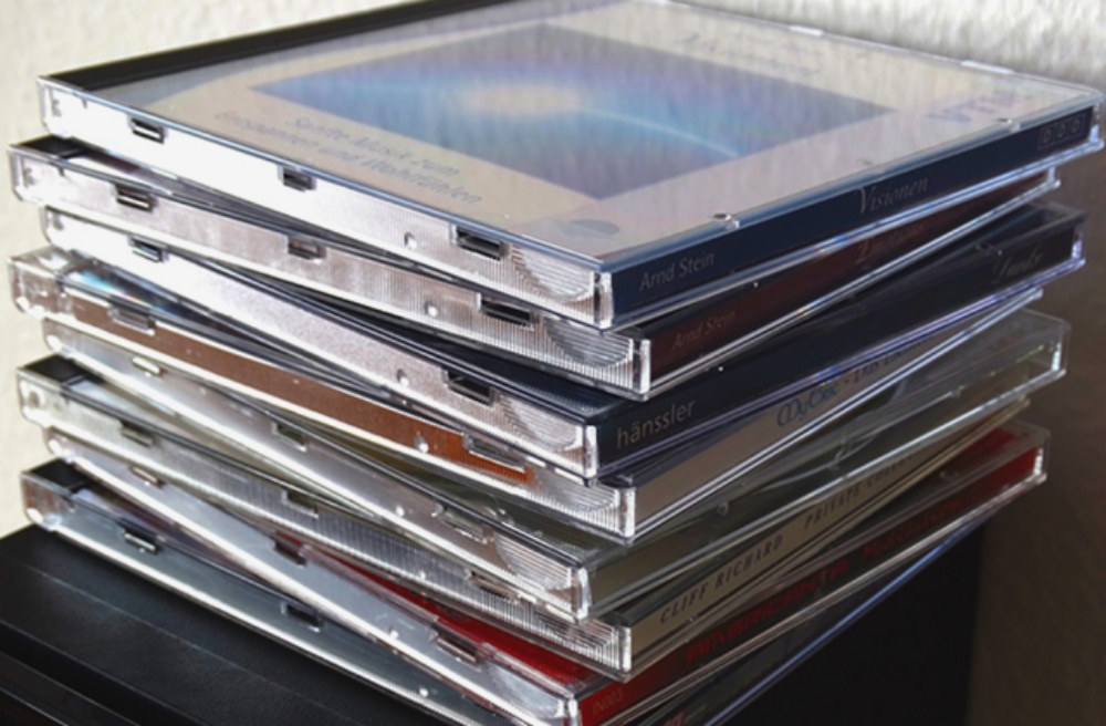 stack of compact disks in jewel cases