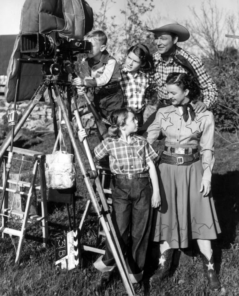 Dale Evans and Roy Rogers with their children on set