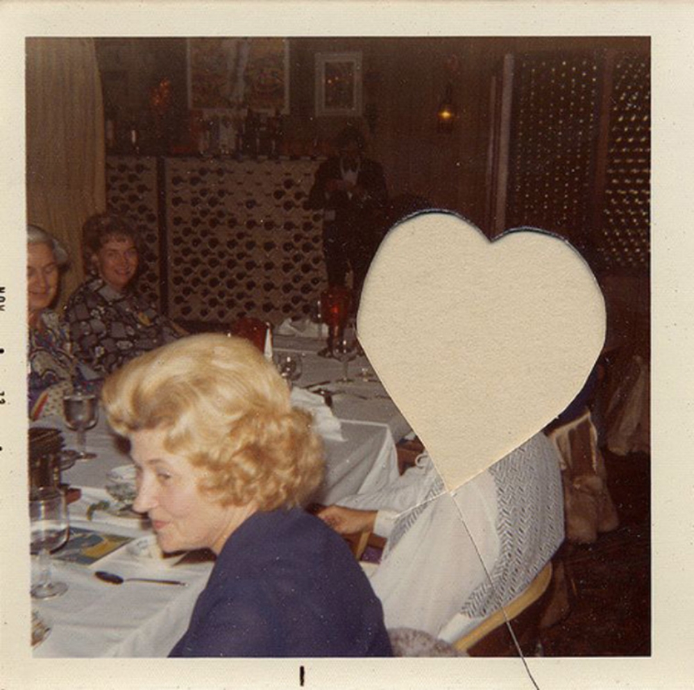 photo with heart-shaped hole where a person's face was