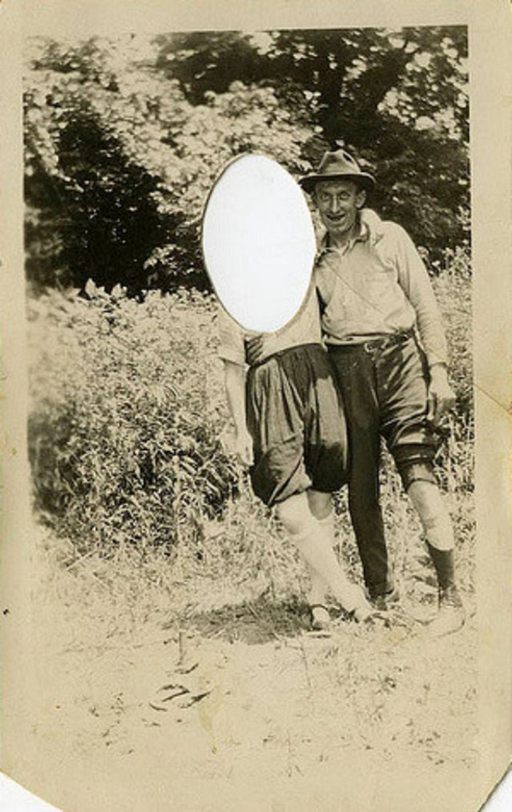 vintage photo of man and women with woman's face cut out in a oval shape