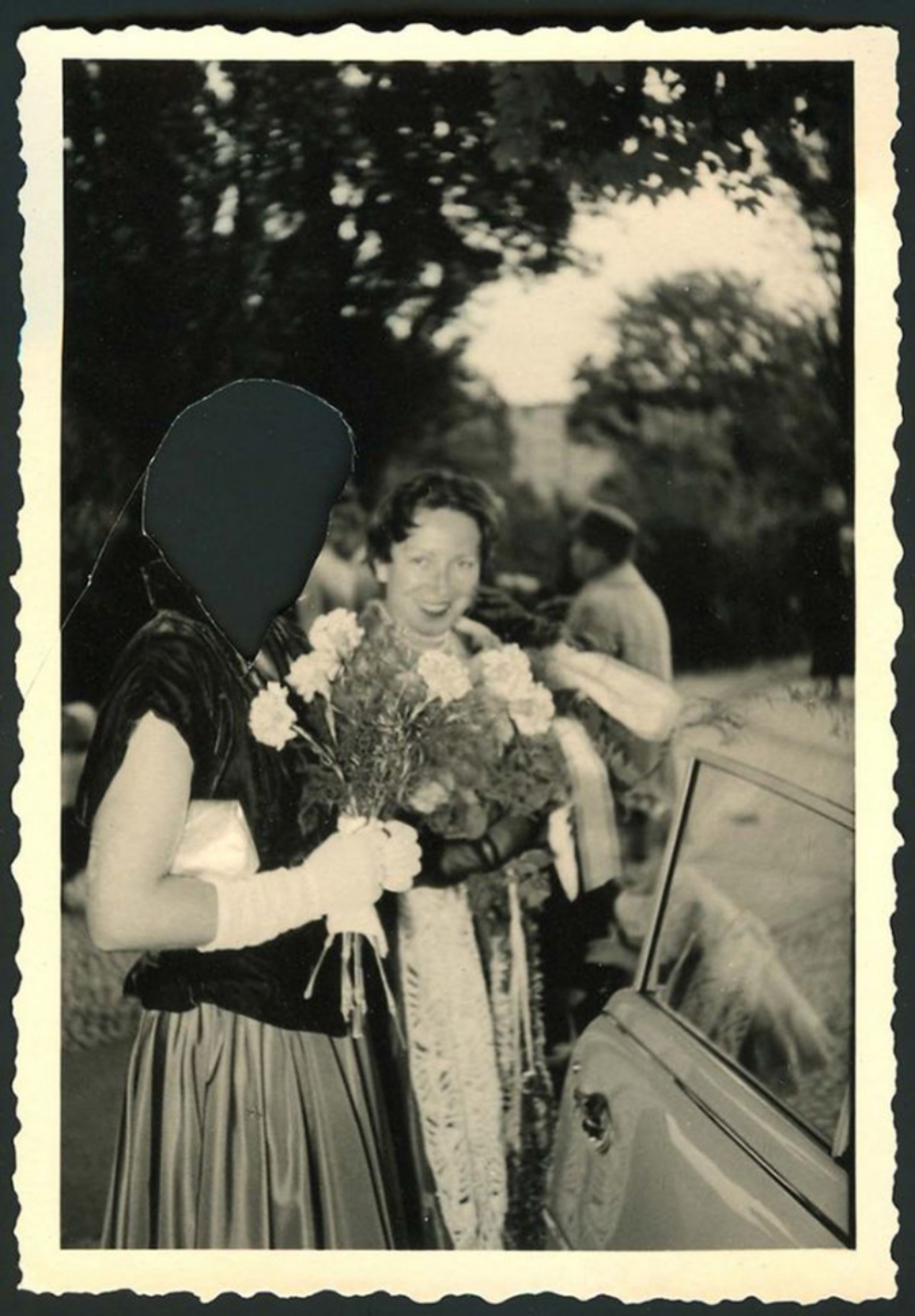 vintage photo of two women leaving a wedding or event, one with her face out out of the picture