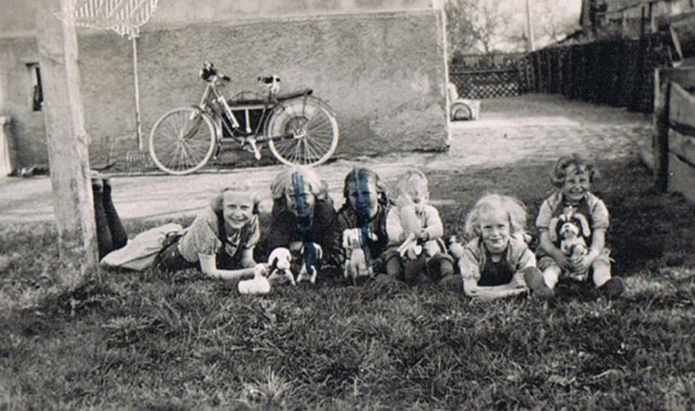 vintage photo of a group of children, two with their faces crossed out in marker