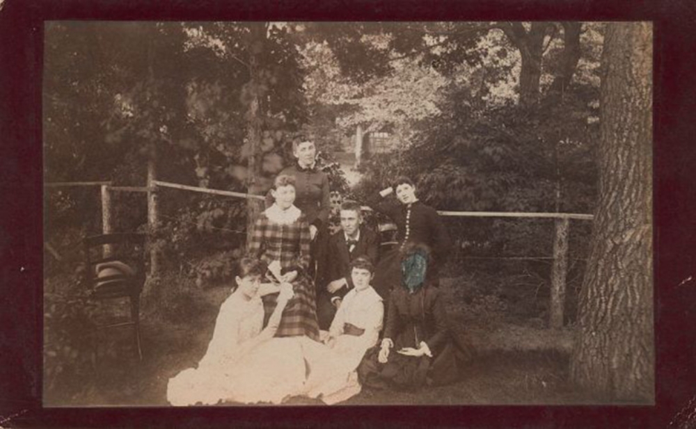 late 19th century group photo with a woman's face cut out