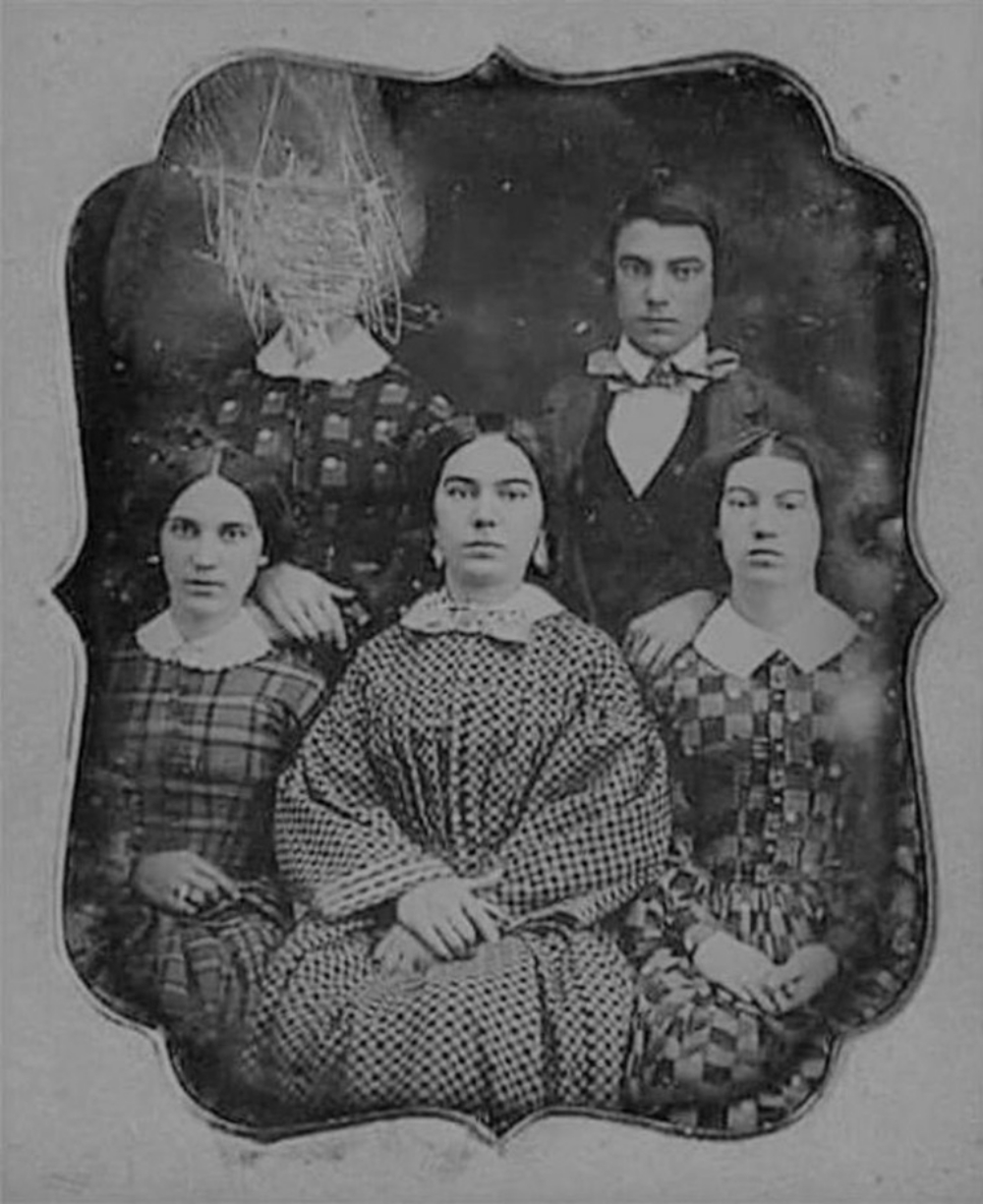 19th century group photo with one's woman's face scratched out