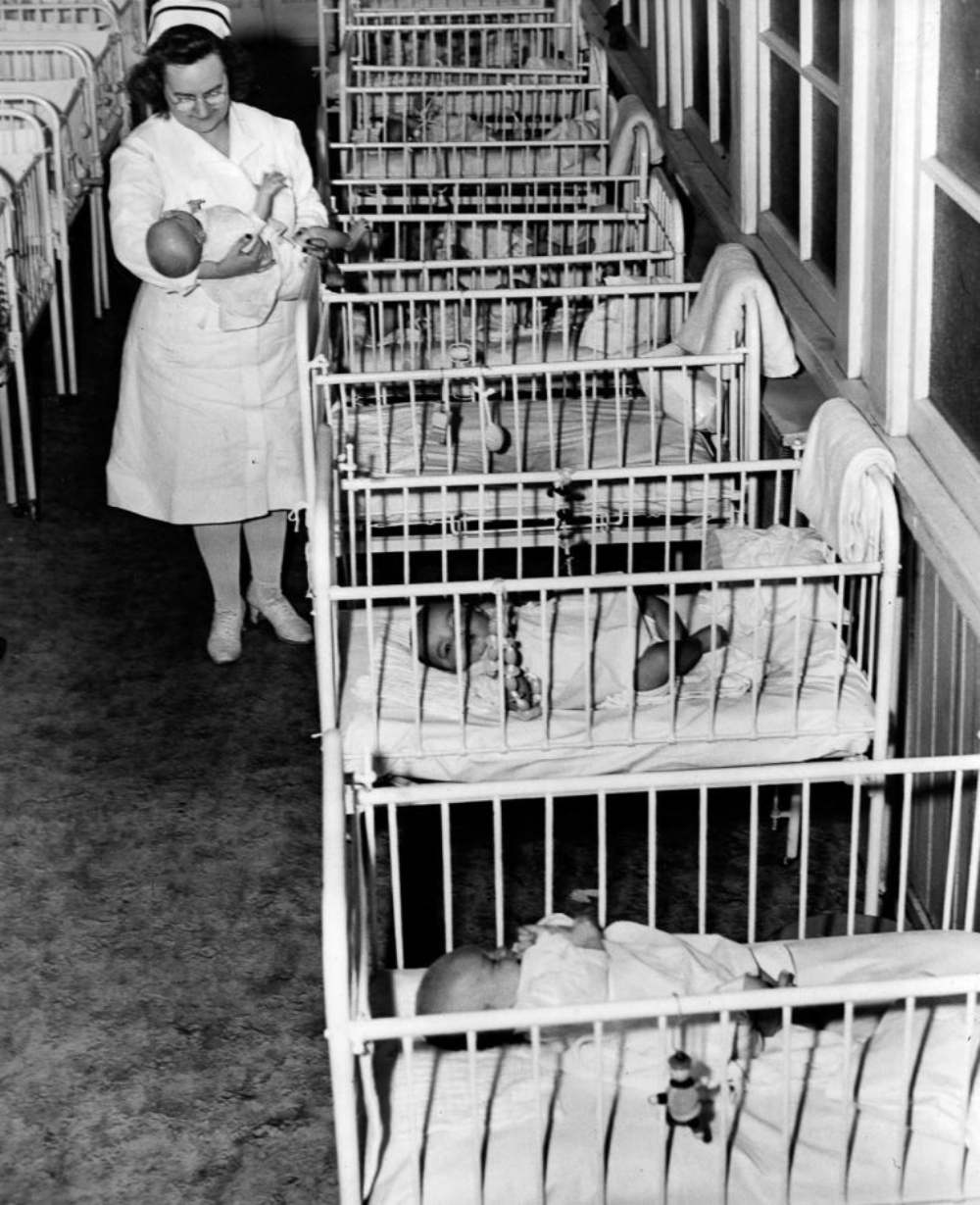 A nurse cares for one of many infants at St. Ann's Infant Asylum in Washington, D.C. 1946.
