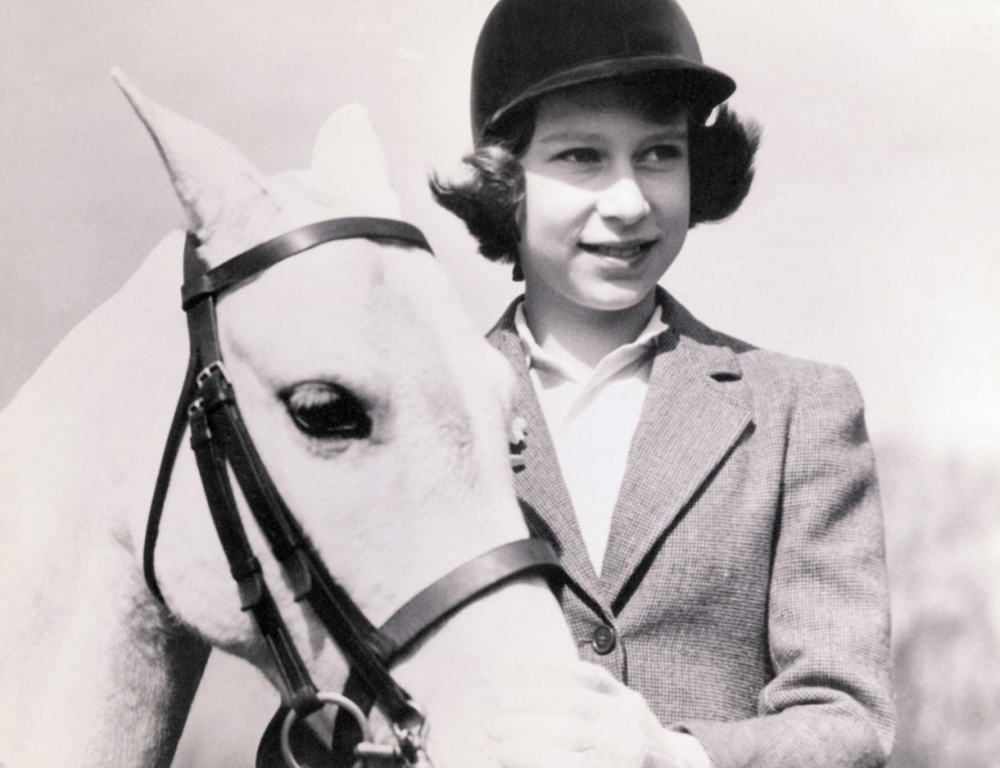 the queen as a child with one of her horses