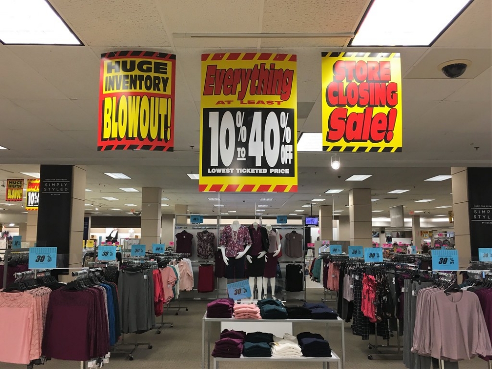 sale signs at a Sears location that is closing down