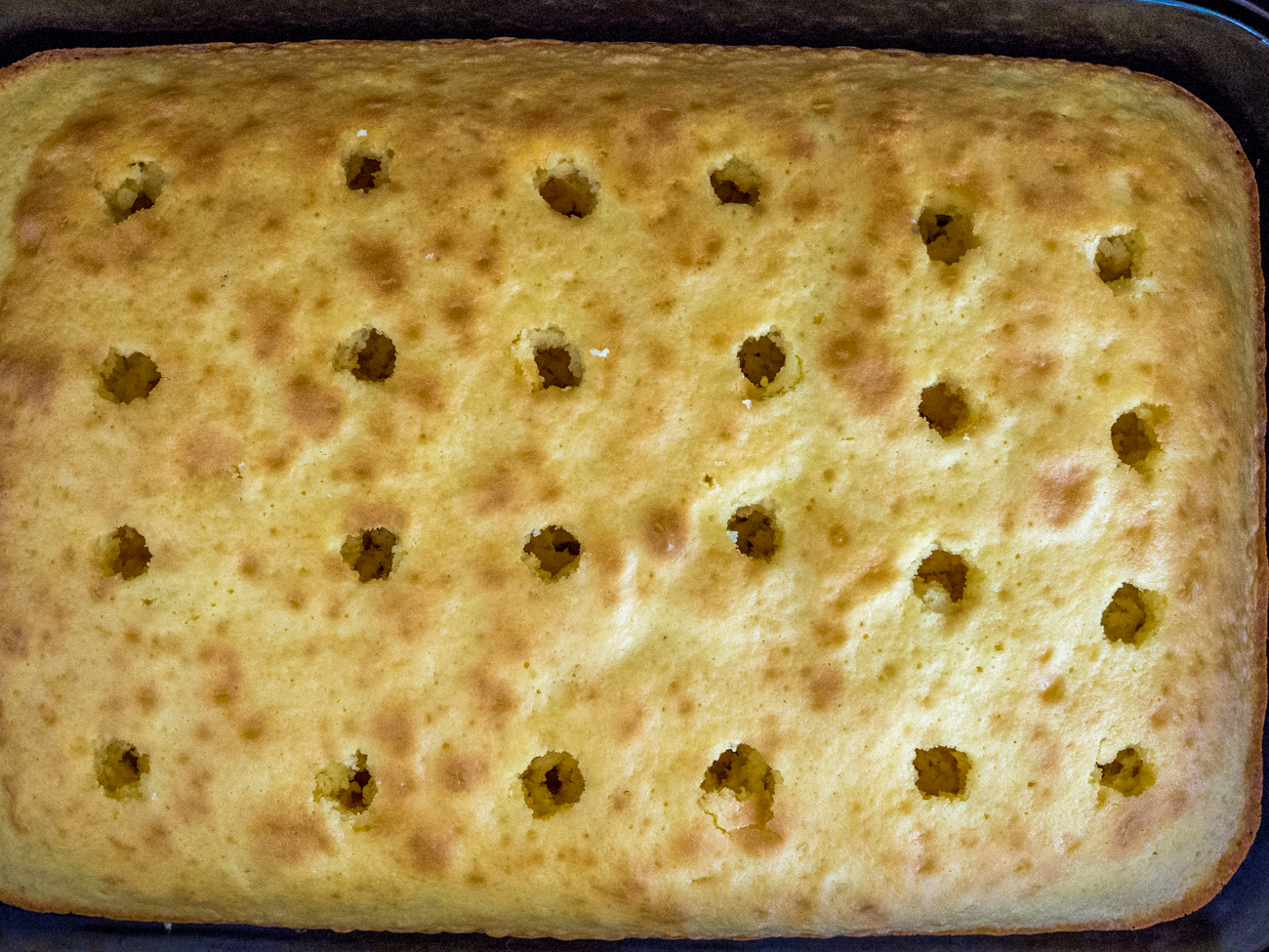 holes poked in Elvis Presley Cake before topping goes on