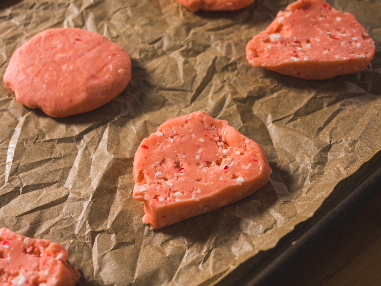 Peppermint Shortbread Cookies spaced on baking sheet and parchment paper