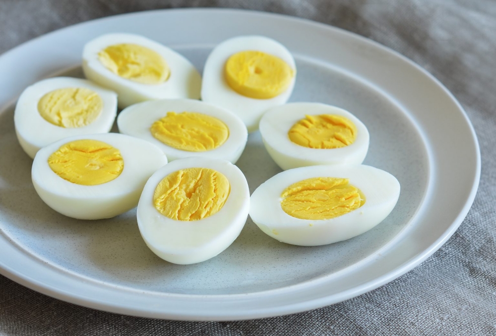 tray of hard boiled eggs cut in half