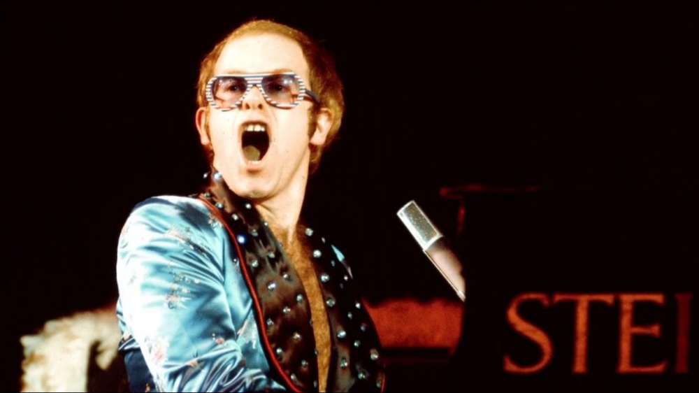 Elton John performing on stage in the 1970s