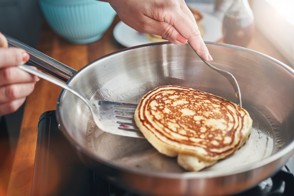 pancake on a spatula inside a pan