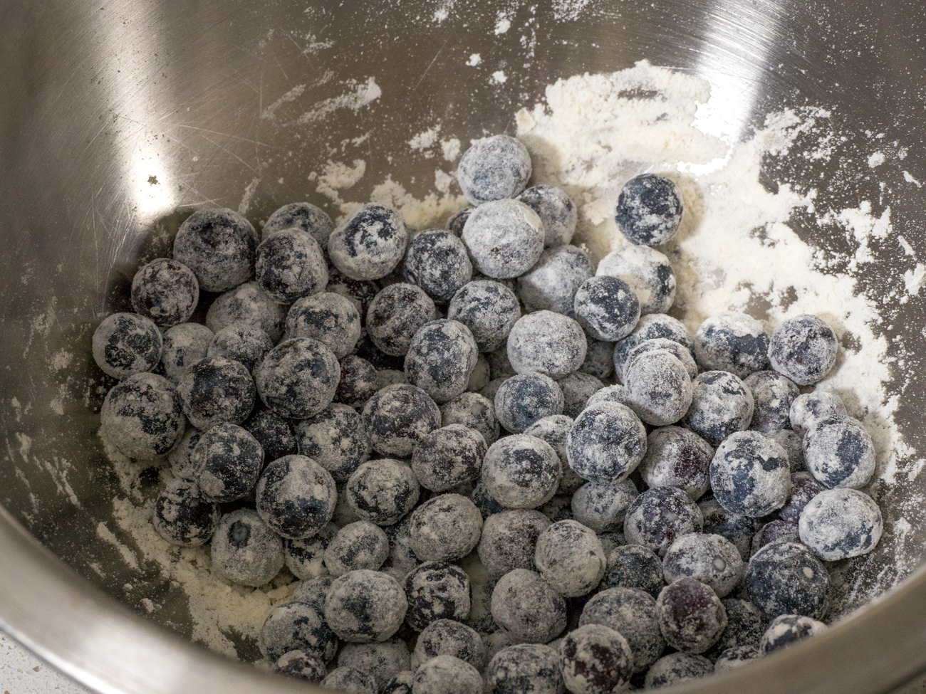 blueberries being dredged in flour