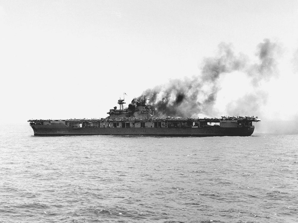 The U.S. Navy aircraft carrier USS Yorktown (CV-5) burning after the first attack by Japanese dive bombers during the Battle of Midway.