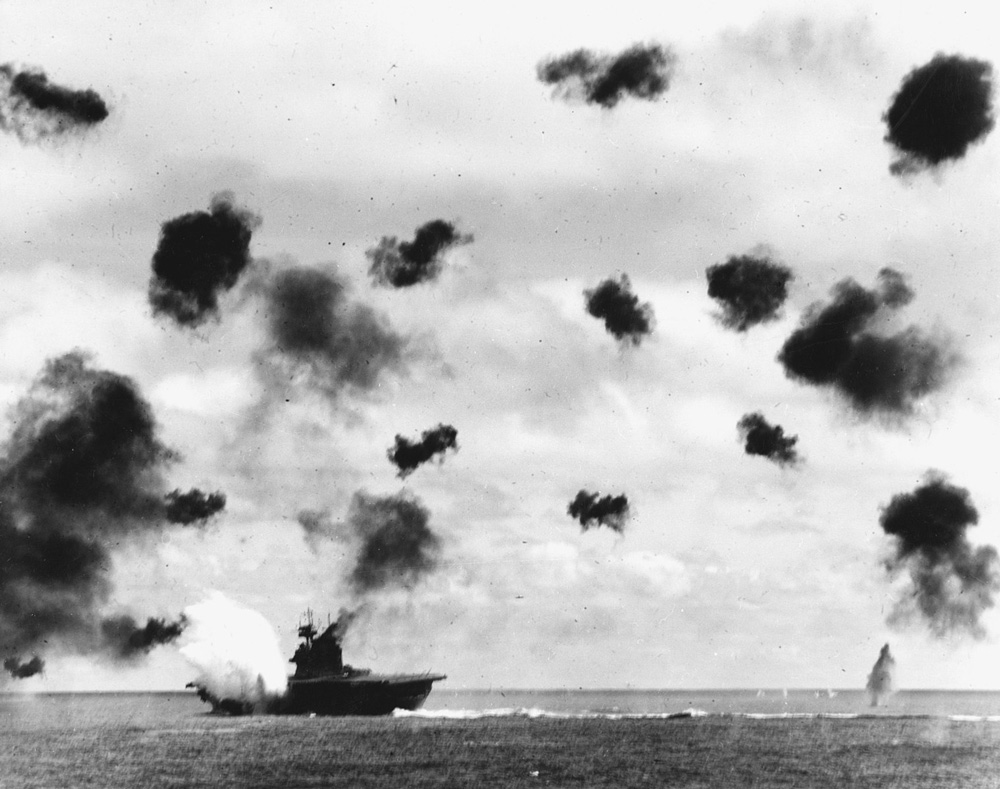 USS Yorktown (CV-5) is hit on the port side, amidships, by a Japanese Type 91 aerial torpedo during the mid-afternoon attack by planes from the carrier Hiryu, in the Battle of Midway.