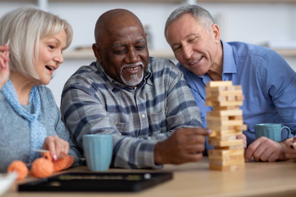 Diverse group of seniors playing board game